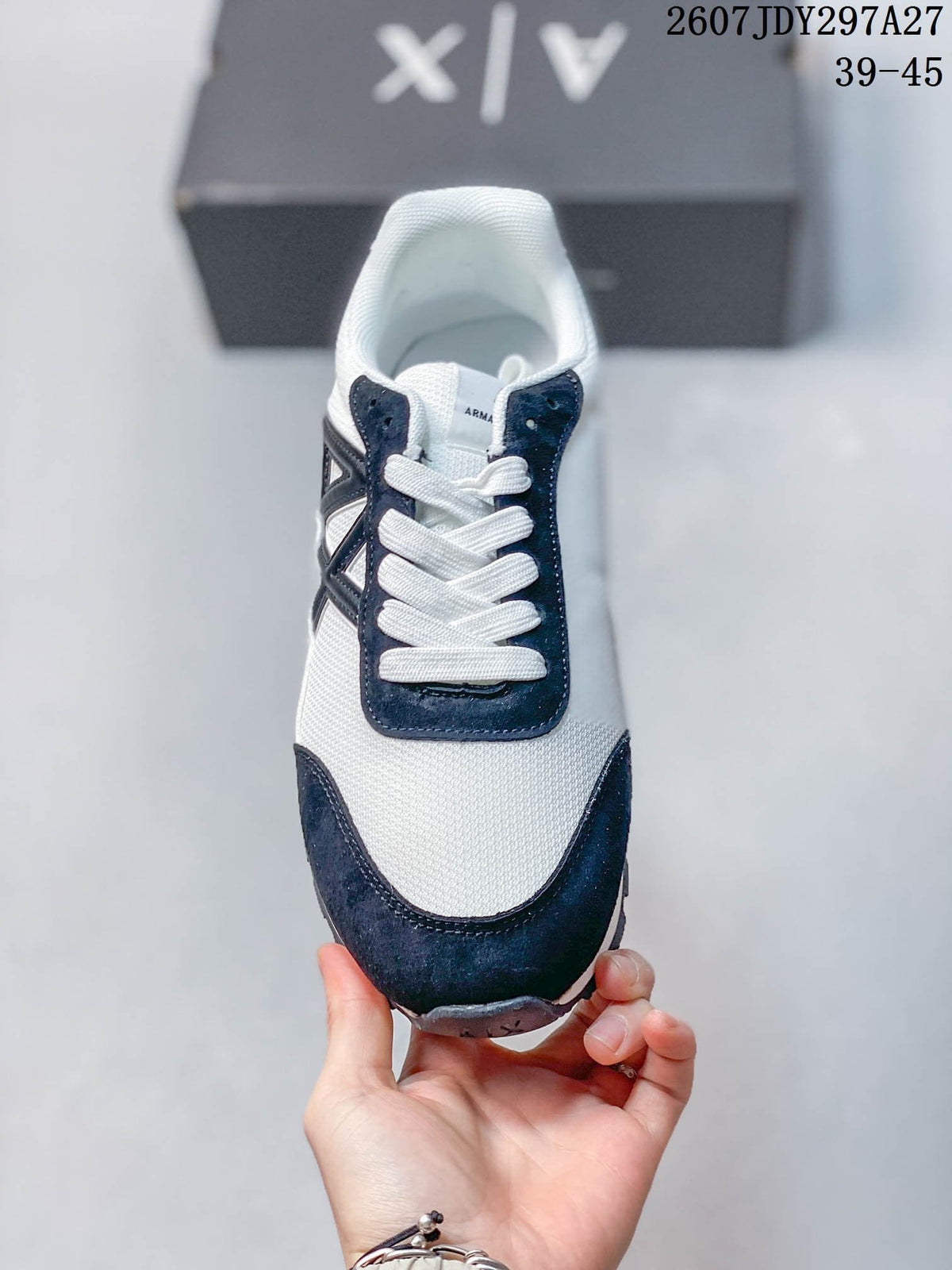 Front view showing the white toe area, navy overlays, and white laces.