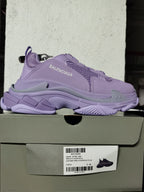 Purple Balenciaga sneaker displayed on its box; the label shows Triple S Clear Sole, style code W73BQ 9590, color purple, and sample size C 39.