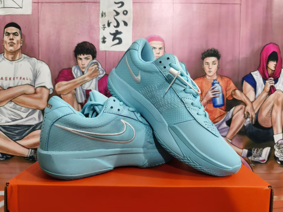 Pair of blue Nike basketball shoes arranged to show their side profiles and mesh uppers.