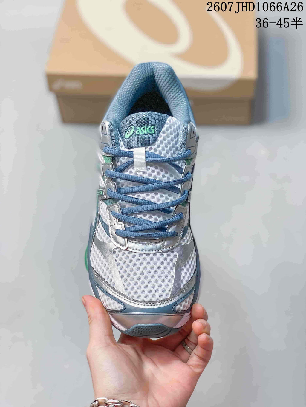 Top view of the ASICS Gel-Cumulus 16 sneaker showing the blue laces, padded tongue, mesh toe box and silver overlays.