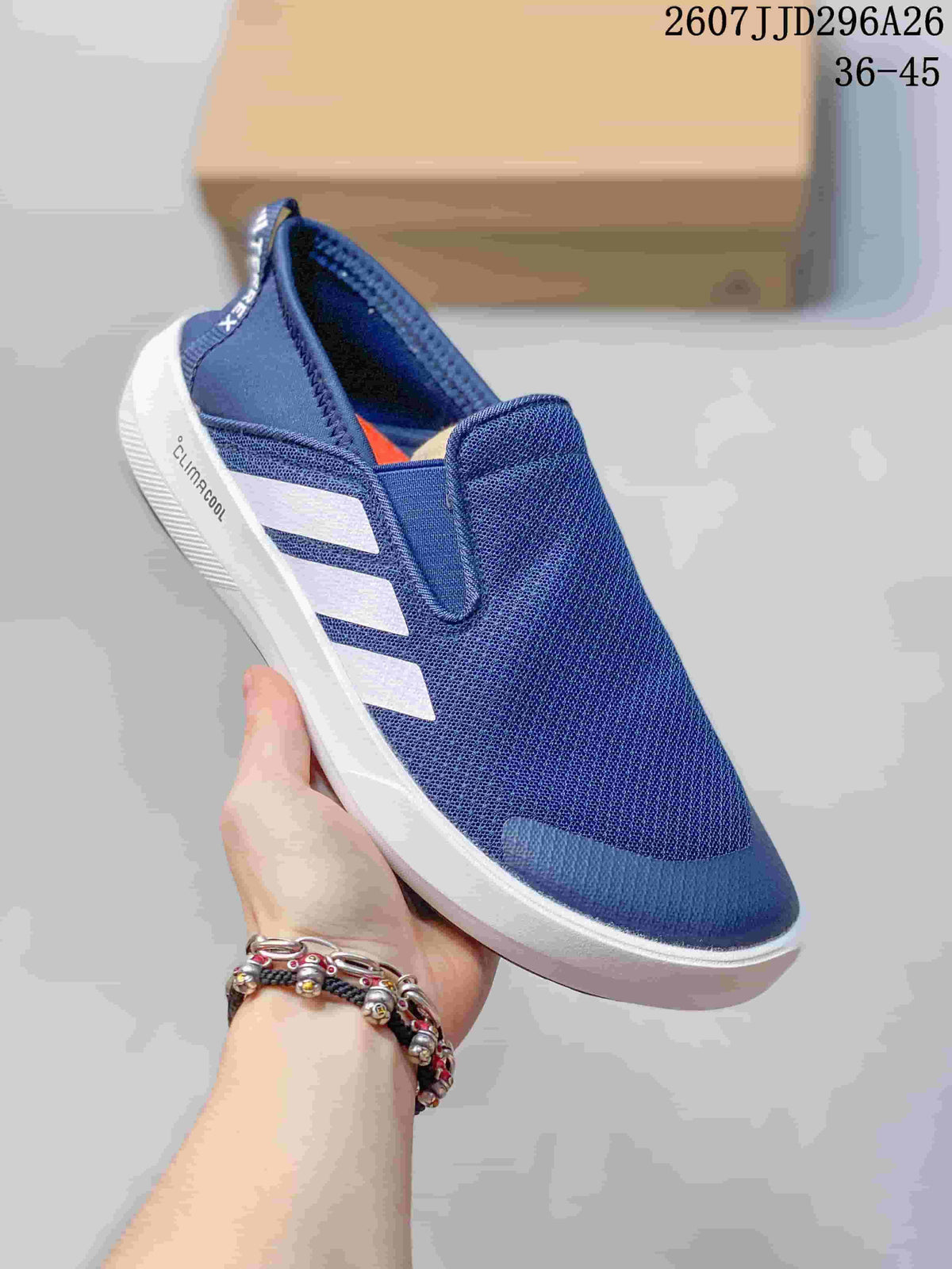 Angled side view of the navy Adidas TERREX slip-on shoe with white stripes and Climacool text on the midsole.