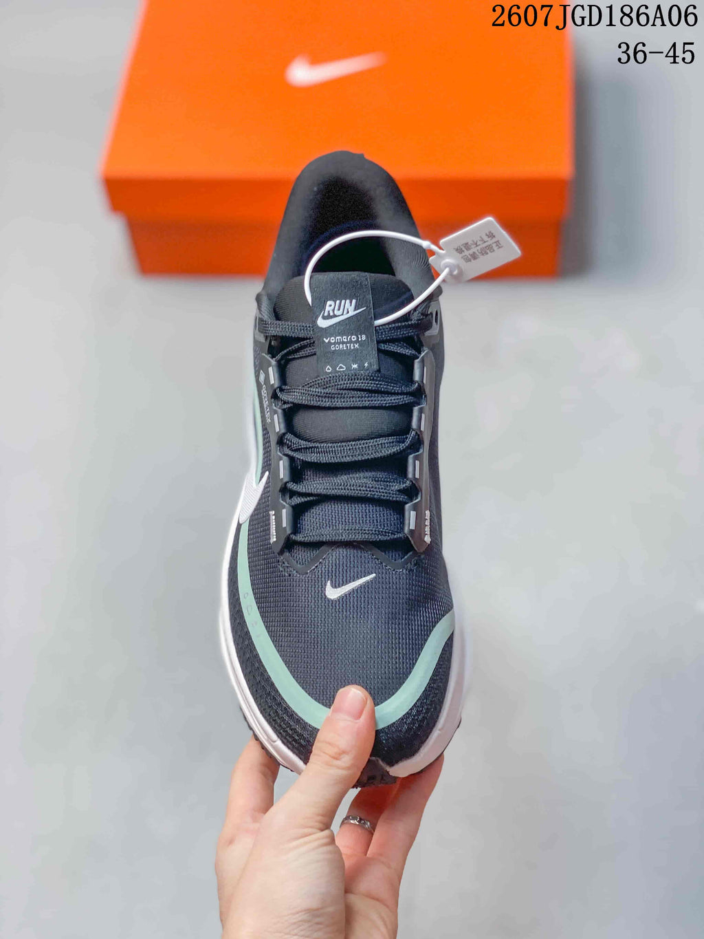 Top view showing the dark upper, layered laces, mint toe accent, and white swoosh.