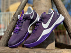 Pair of purple Kobe 8 shoes shown at an angle.