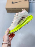 Side profile of the sneaker showing the light gray and pink upper, Nike branding, GORE-TEX marking, and neon yellow midsole.
