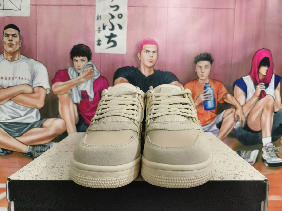 Front view of beige Nike sneakers with tonal laces and layered toe overlays.