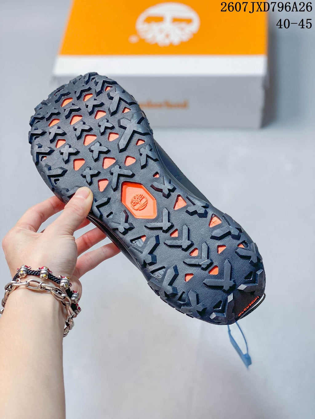 Close view of the rugged outsole with deep directional lugs and an orange Timberland detail.