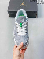 Front view showing perforated toe, white laces, and green lace detail