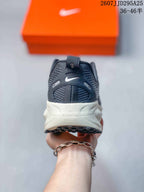 Rear view of the Nike Vomero 18 showing the padded heel, pull tab, dark upper, and midsole markings for ZoomX and ReactX.