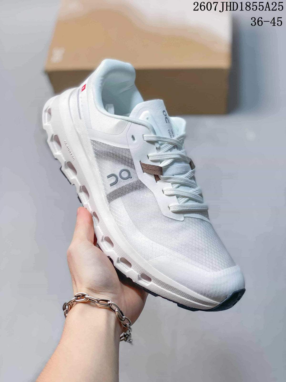 Angled side view of the white and light gray On sneaker showing the layered upper, padded collar, sculpted midsole, and dark outsole; overlay text shows style code 2607 JHD1855A25 and size range 36-45.