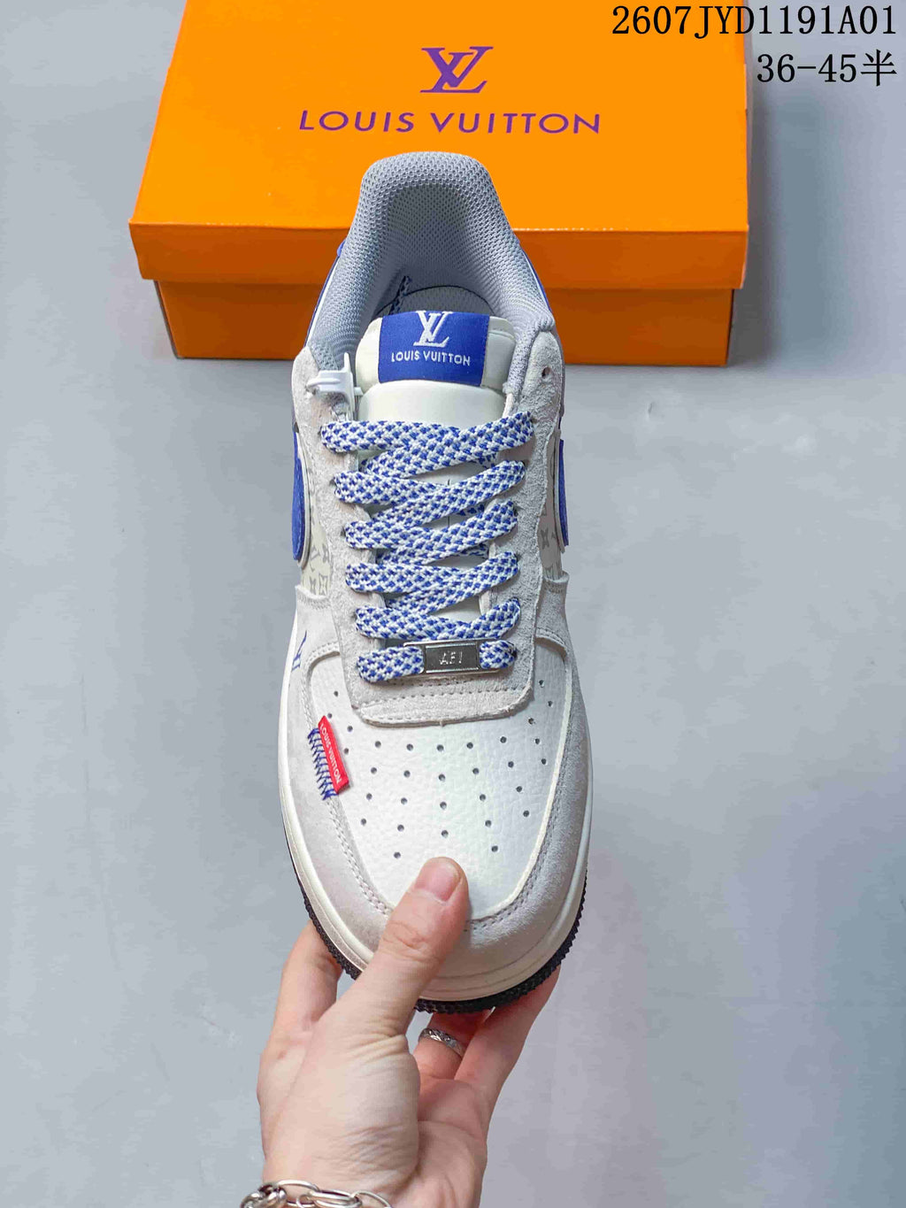 Front view showing the perforated toe, patterned laces and blue tongue label.