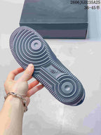 Outsole view showing the circular traction pattern and textured rubber tread of the dark sneaker.