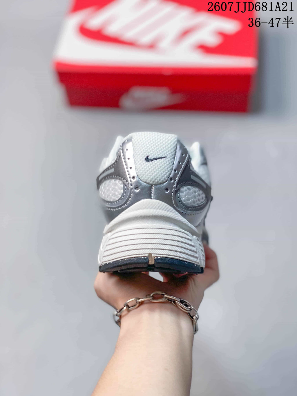 Rear view of the white and grey Nike V5 RNR sneaker showing the padded heel and layered heel construction.
