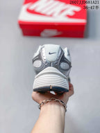 Rear view of the white and grey Nike V5 RNR sneaker showing the padded heel and layered heel construction.