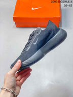 Side view of the dark gray Nike Free sneaker showing the knit-style upper, Nike Swoosh, padded collar, and grooved sole.