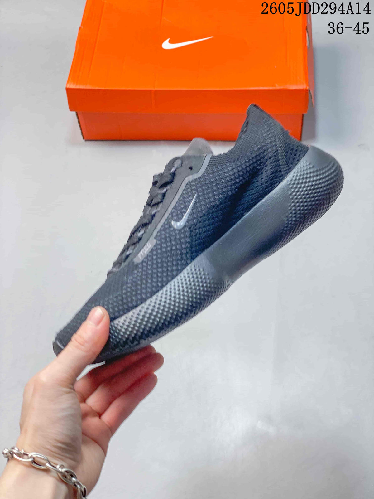 Side view of the dark gray Nike Free sneaker showing the knit-style upper, Nike Swoosh, padded collar, and grooved sole.