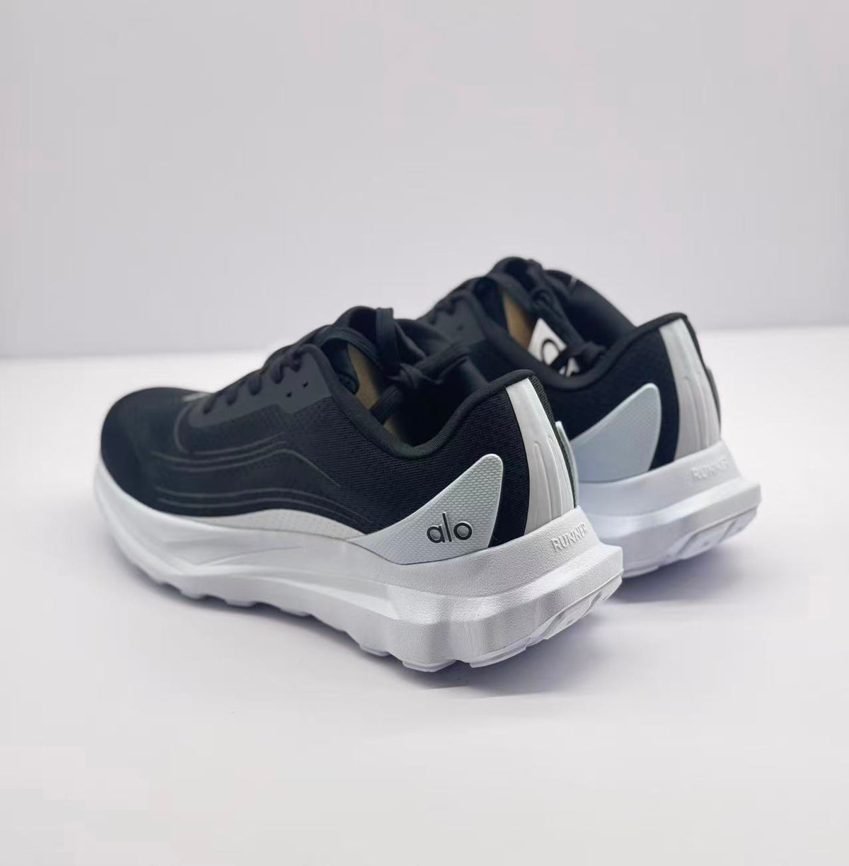 Rear-side view highlighting the black uppers, white heel accents, and outsole edges.