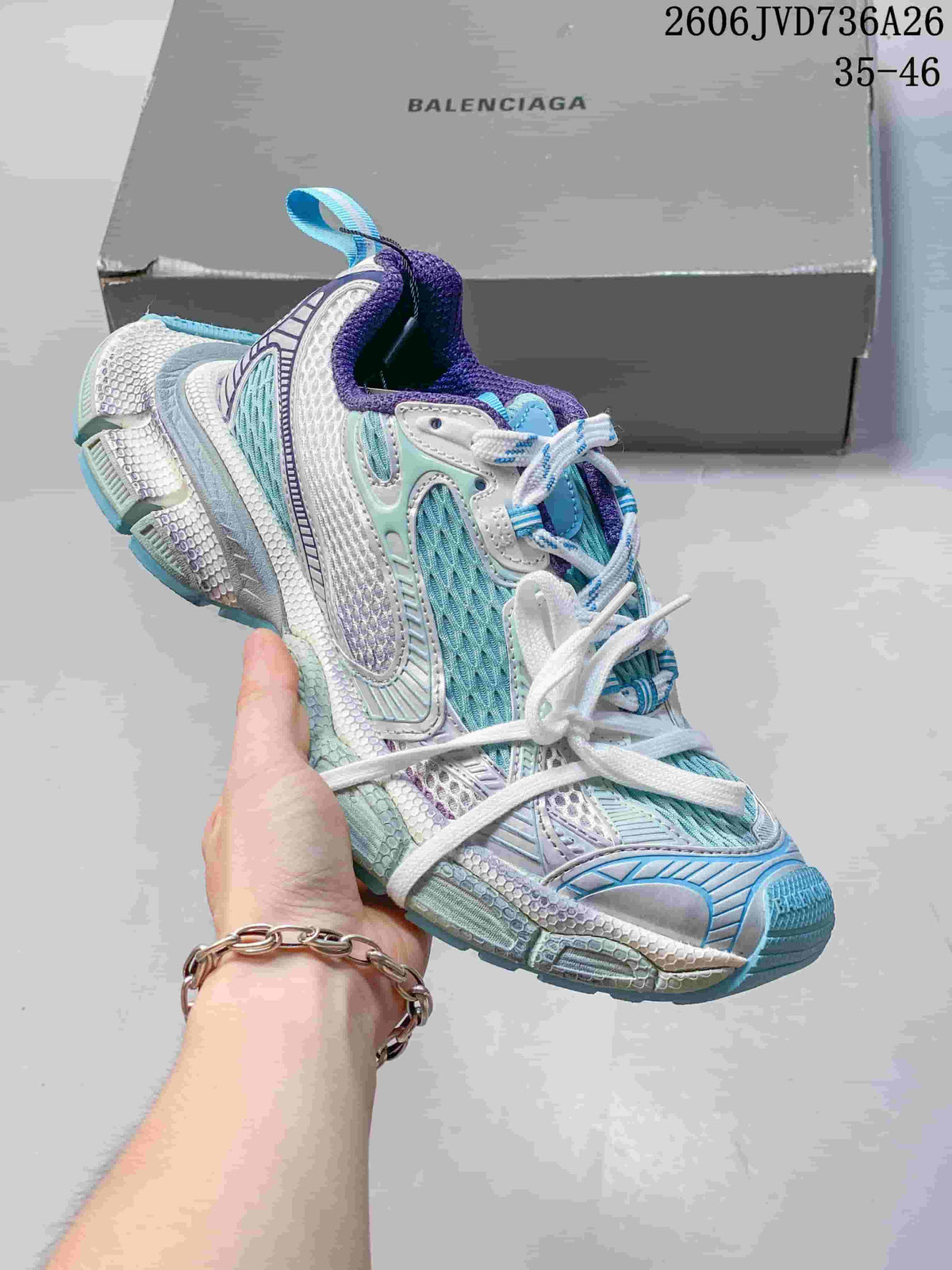 White Balenciaga 3XL-style sneaker with pale blue and purple accents
