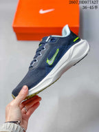 Side profile of a navy Nike running sneaker with a white Swoosh, lime detailing, and white midsole.