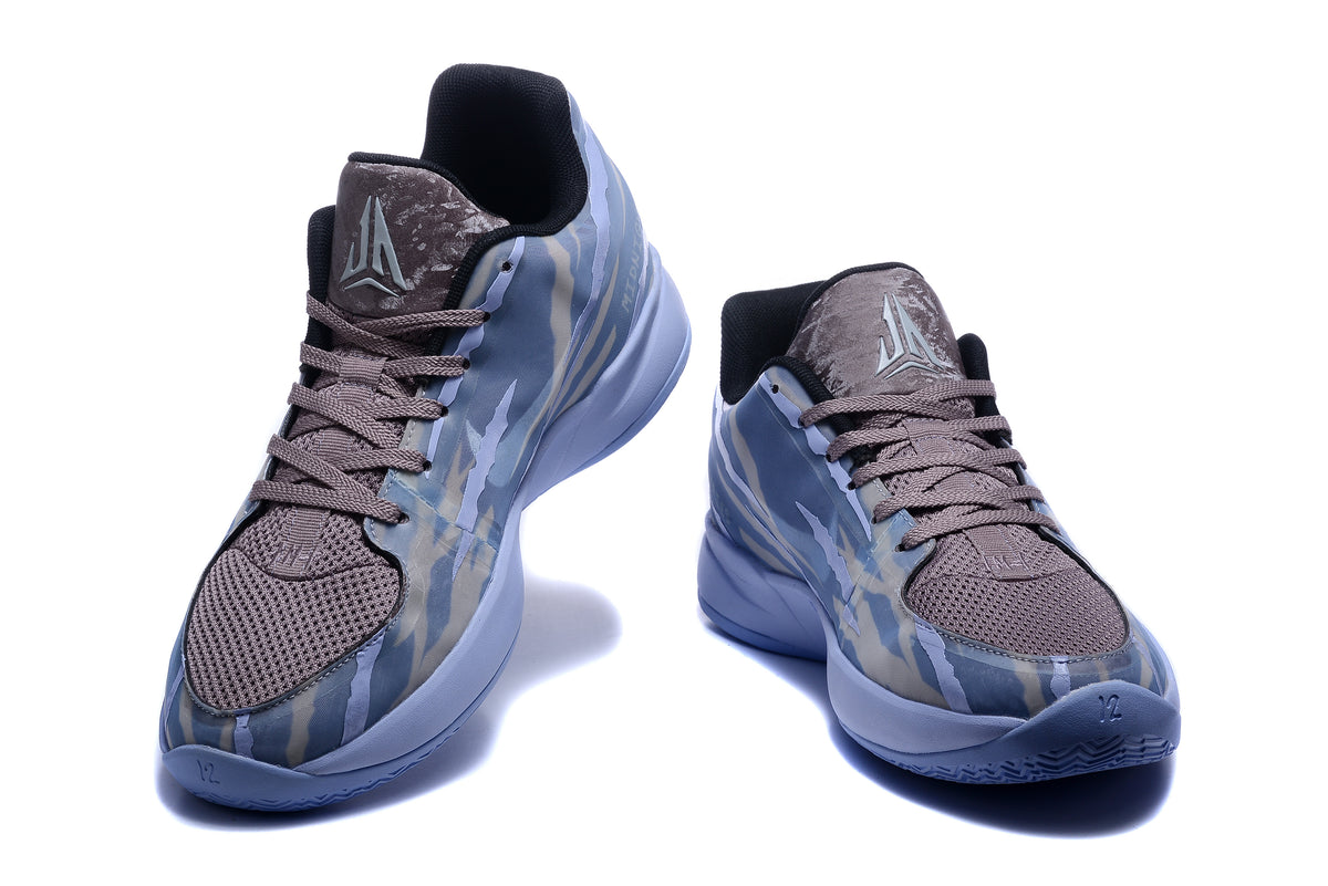 Front view of blue-gray basketball shoes with patterned uppers and contrasting laces