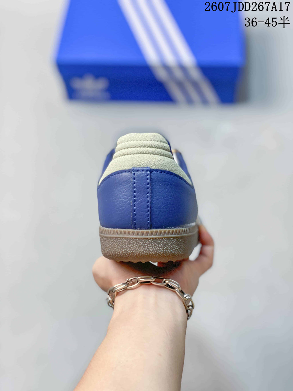 Rear view of the blue sneaker showing the padded heel and gum-colored outsole edge.