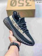 Black knit sneaker with a cream side stripe, black laces, and a ribbed black sole.