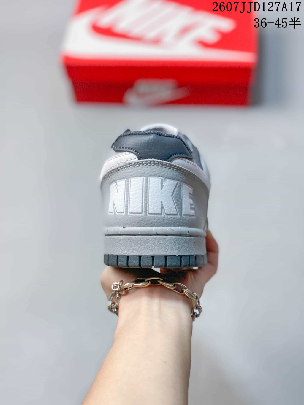 Rear view showing the padded heel area, embossed Nike branding, and dark outsole edge.
