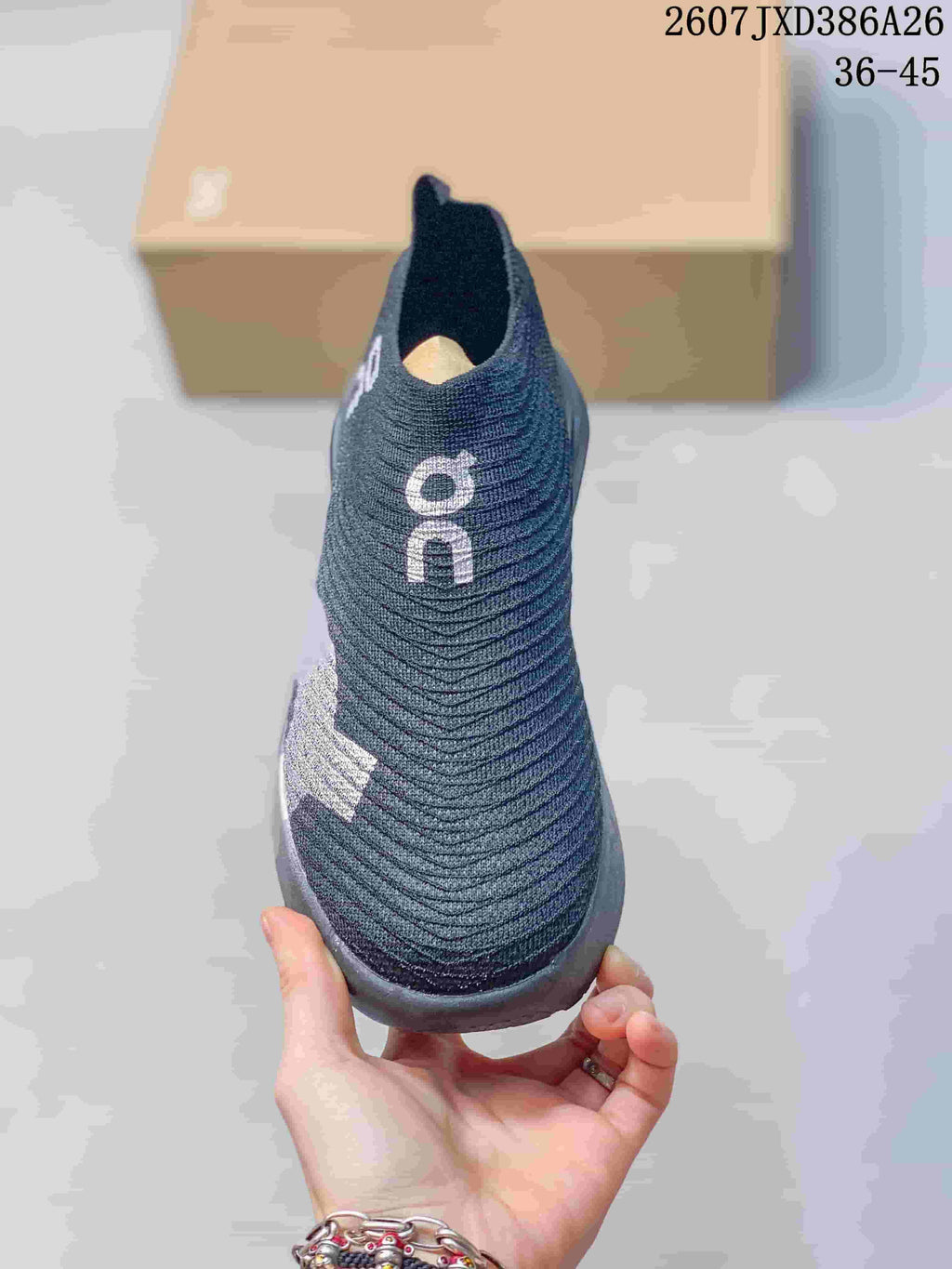 Front view showing the rounded toe, knit upper, and On branding.