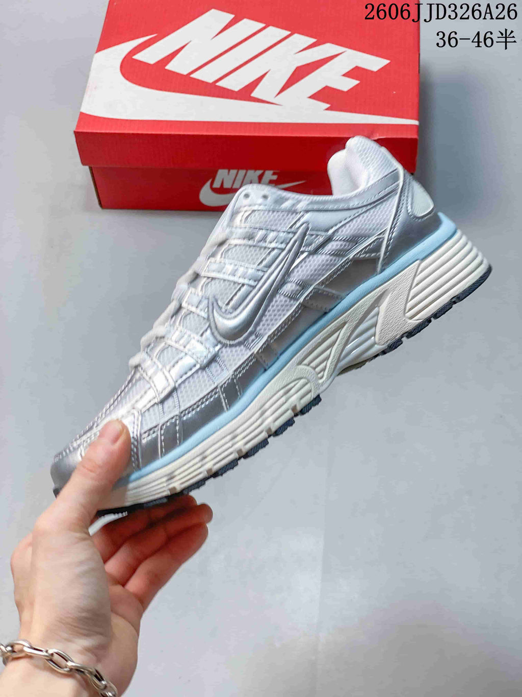 Side profile showing the layered panels and pale blue accents on a Nike P-6000 sneaker