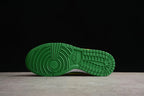 Bottom view showing the green outsole with circular forefoot and grid-pattern tread.