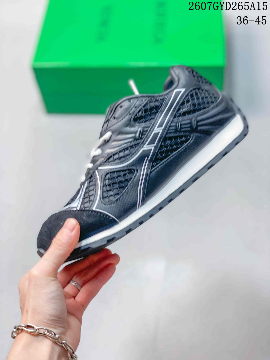 Side profile of the black and white low-top sneaker showing contrast detailing, mesh-style panels, and a layered sole.