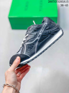 Side profile of the black and white low-top sneaker showing contrast detailing, mesh-style panels, and a layered sole.