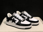 Three-quarter product view showing the black-and-white colorway, star side branding and white midsoles.