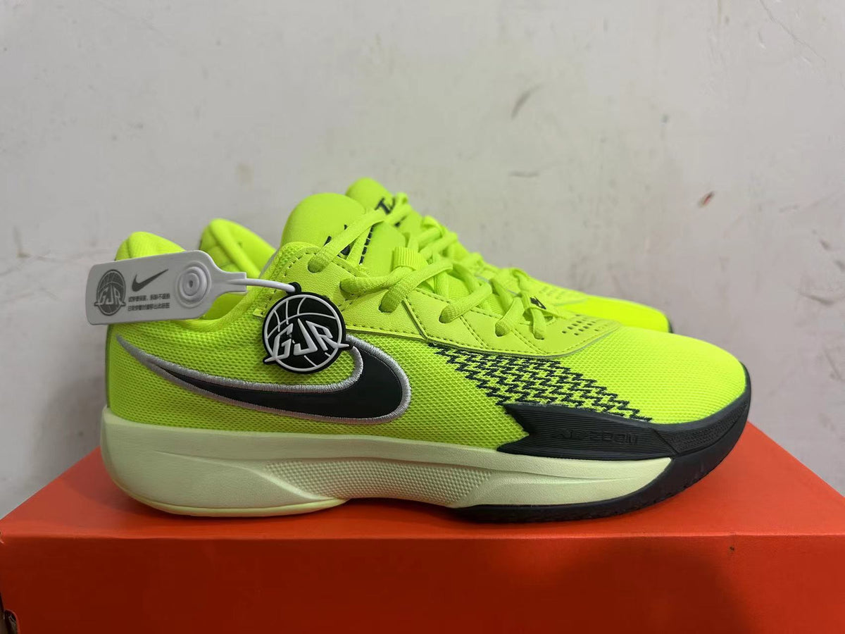 Side profile of bright green Nike basketball shoe with a dark side logo, patterned panel, and pale sole
