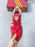 Top view of the red sneaker showing red laces, textured panels, and white stripes.