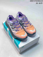 Purple, orange, and gray adidas Equipment Adios Pro sneakers displayed on an adidas shoe box.