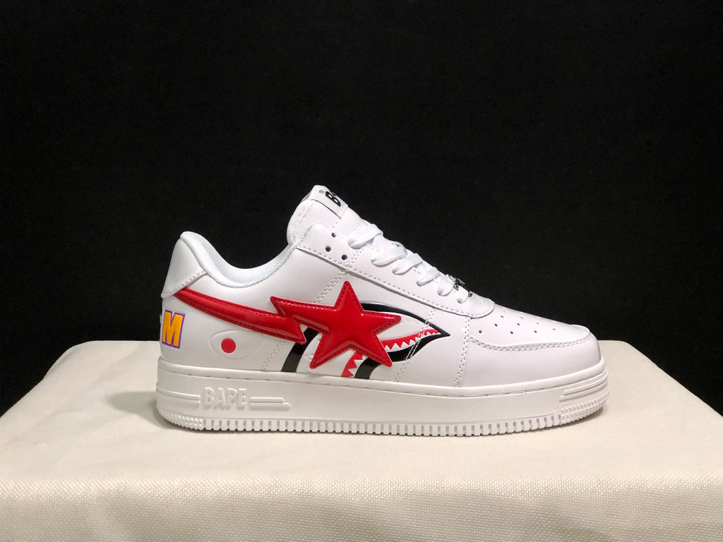 Side profile showing the white sneaker, red star and shark-inspired graphic, BAPE branding on the midsole, and multicolored heel detail.