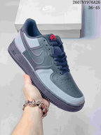 Gray Nike Air Force 1 '07 LV8 sneaker with black details and a red tongue label.