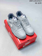 Pair of grey and white Nike SB Dunk Low Pro sneakers displayed on a red shoebox; overlay shows style code JJD127A17 and a size range.
