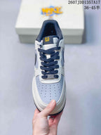 Top view showing the gray perforated toe box, dark laces, white overlays, and yellow tongue detail.