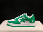 Side profile of a white and green BAPE STA sneaker showing the large star graphic, heel ape-head emblem, and green outsole.