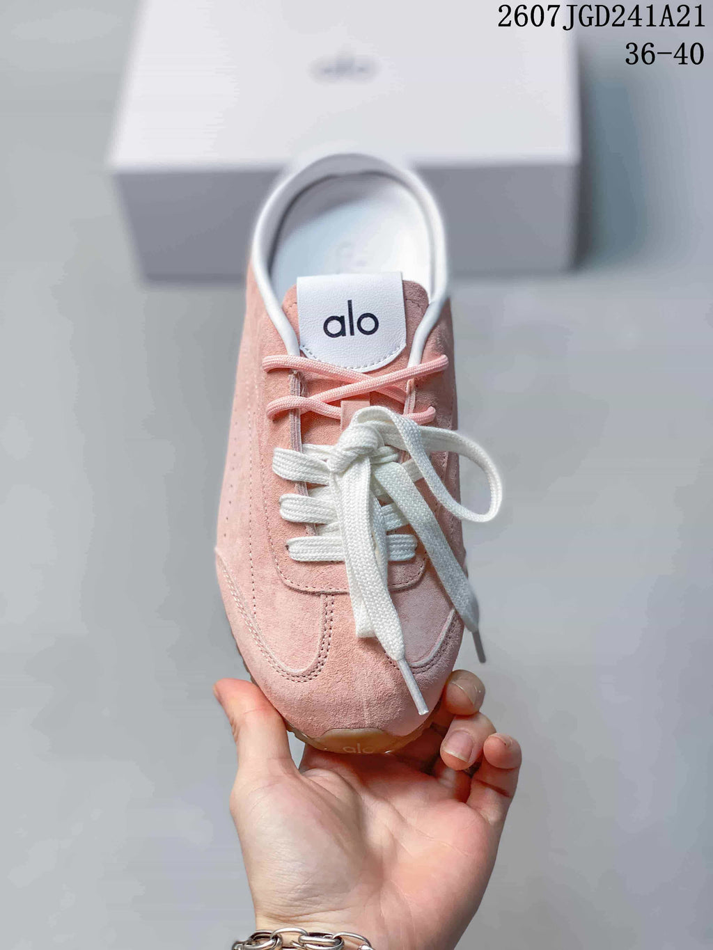 Top view showing the pink upper, white laces, and Alo tongue branding.