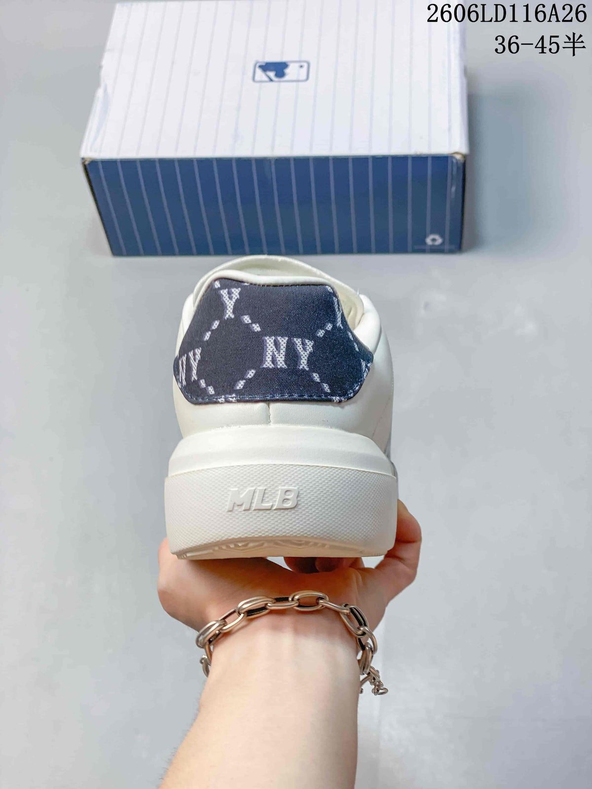 Rear view of the white sneaker showing the patterned heel panel and raised sole with MLB lettering.