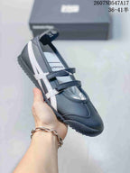 Dark gray Mary Jane sneaker with contrasting white side stripes and two strap closures.