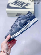 Side profile showing the plaid panels, layered overlays, contrast stitching, and white midsole.