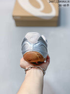 Rear view of the sneaker showing the padded heel, ASICS branding, and gum-colored heel traction section.