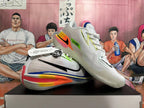 Angled view of white Nike GT basketball shoes with bright heel accents and black Swoosh.