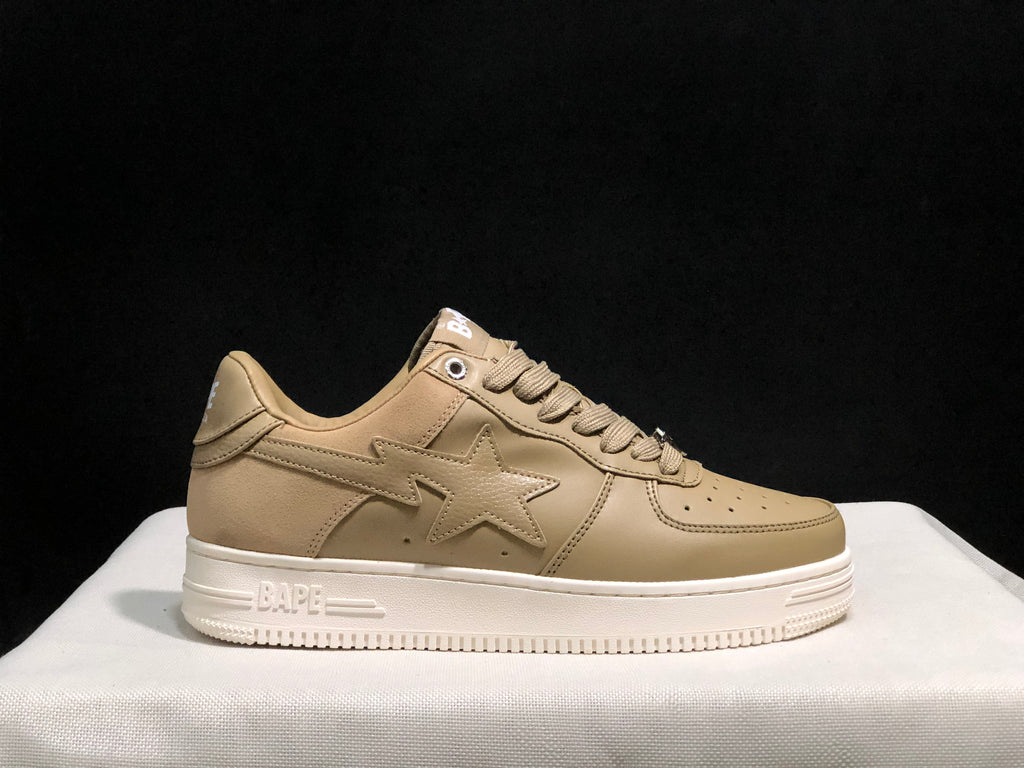 Side view of a beige BAPE STA sneaker showing the star applique, perforated panels and embossed sole branding.