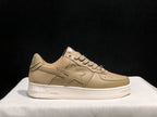 Side view of a beige BAPE STA sneaker showing the star applique, perforated panels and embossed sole branding.