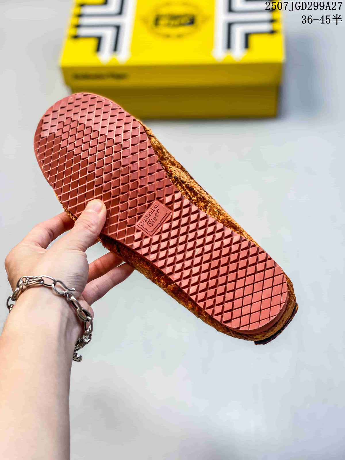 Underside of a sneaker showing a red-brown textured rubber outsole with a diamond tread pattern.
