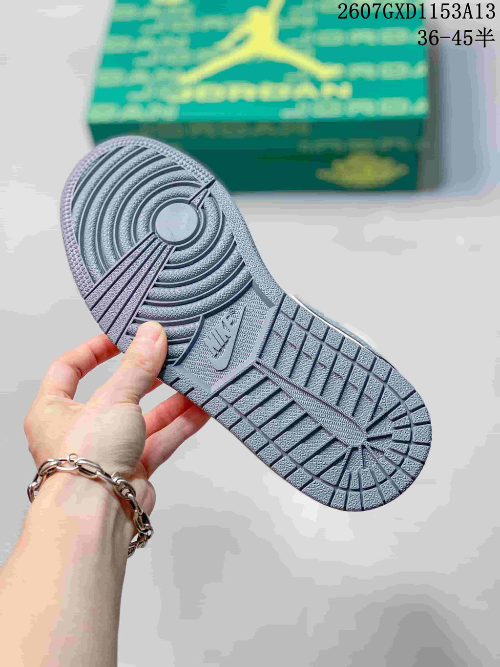 Close-up of the patterned rubber outsole with circular and grid traction details.